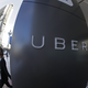 FILE - In this file photo taken, Dec. 16, 2014, a woman leaves the headquarters of Uber in San Francisco, Calif. Uber drivers are employees, not independent contractors, the Oregon Bureau of Labor and Industries said Wednesday, Oct. 14, 2015, in an opinion that takes direct aim at the business model for the popular ride-hailing company.